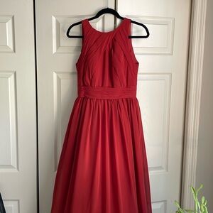 Floor length, burnt orange dress.